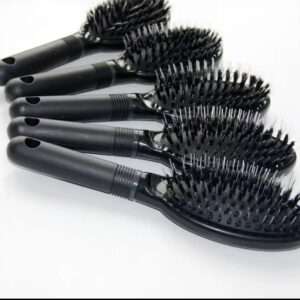 A row of five professional black hairbrushes featuring mixed bristles, designed specifically for grooming and maintaining hair extensions.